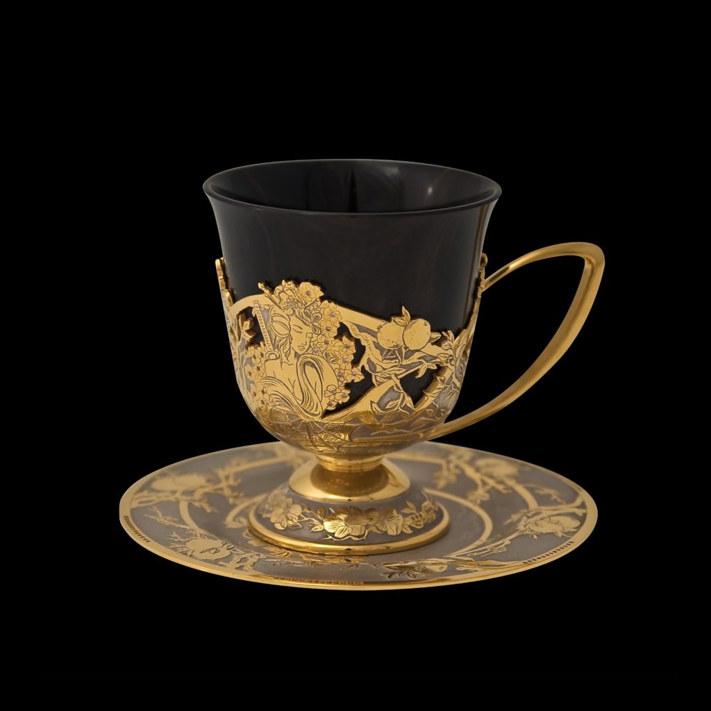 Handmade coffee cup, inlaid with stones, carved pattern and covered with gold