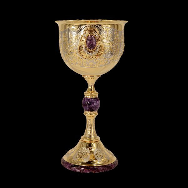 Luxury goblet made of gold and natural stones. The subject of design and interior