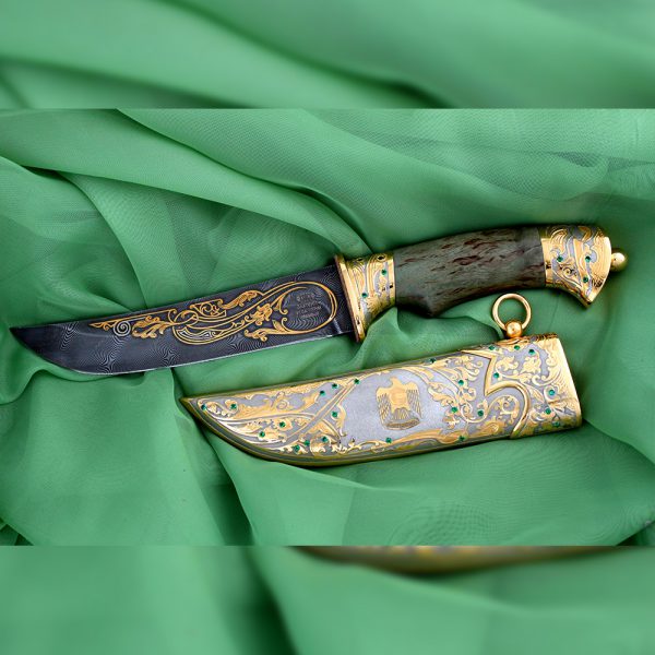Knife with green jewelry stones and a UAE gold falcon