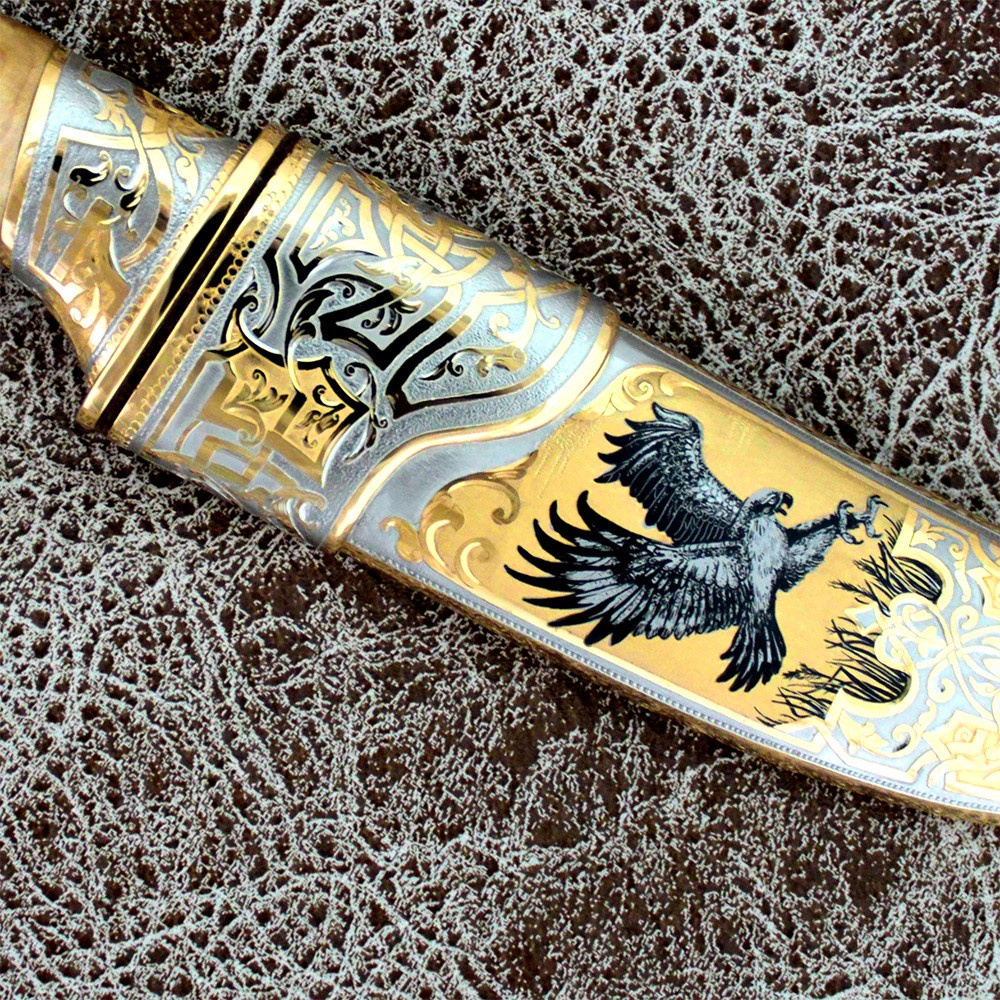 The sheath of the knife is decorated with an art drawing of bird hunting
