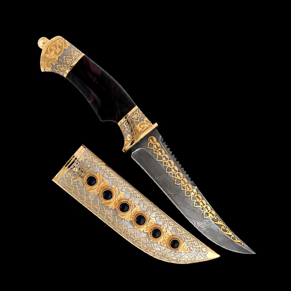 A luxury knife for an expensive gift. Gold sheath decorated with carved inserts. The handle with a subdigital recess is molded from resin carved