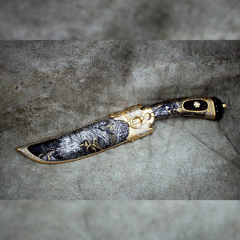 Knife - Bear. The knife is richly decorated with drawings of bear hunting.