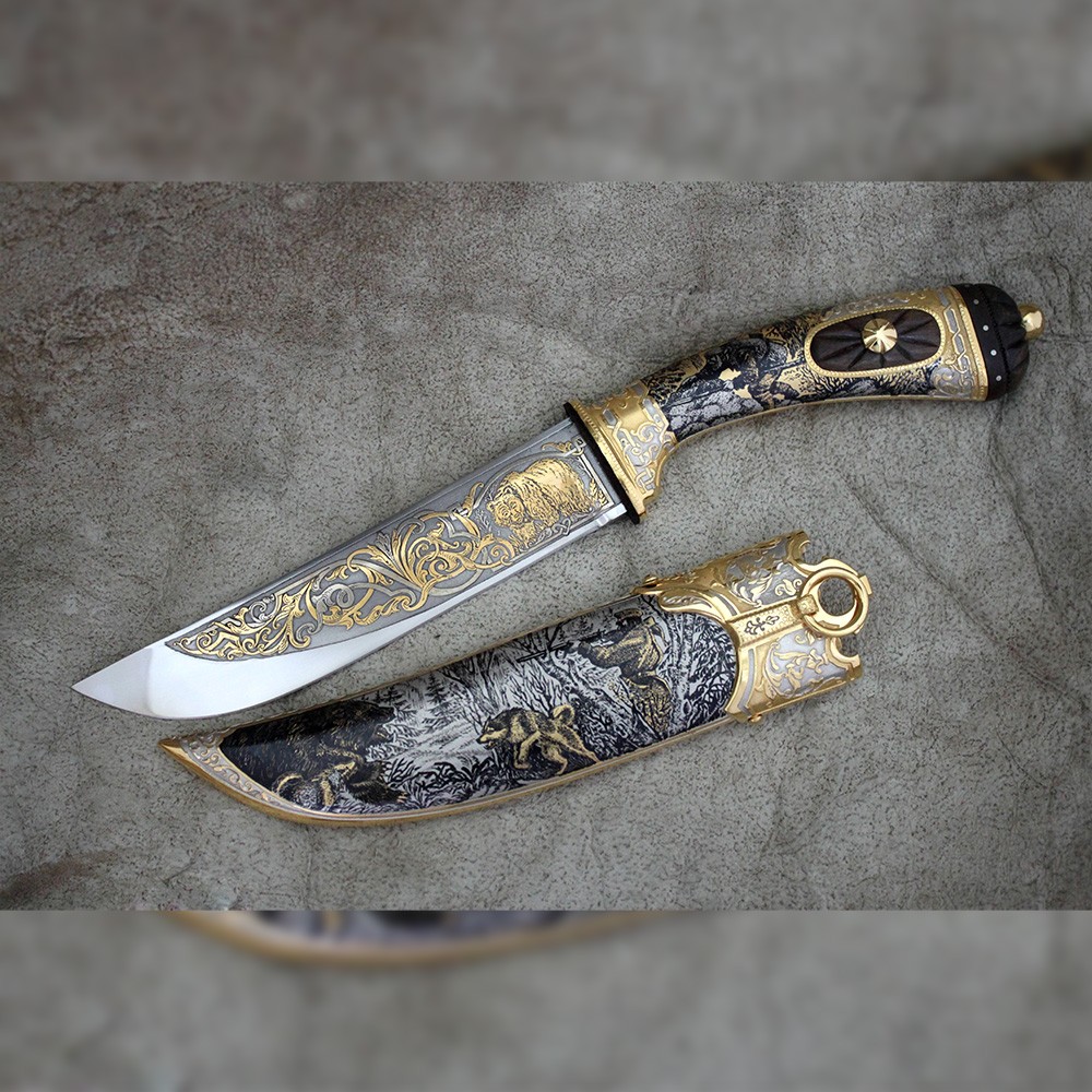 Knife - Bear. The knife is richly decorated with drawings of bear hunting.