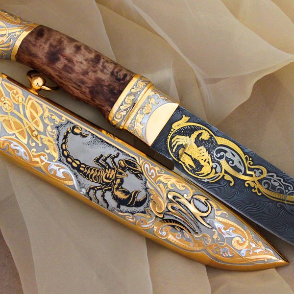 Handmade knife - Scorpio. The damascus steel blade depicts a golden scorpion.