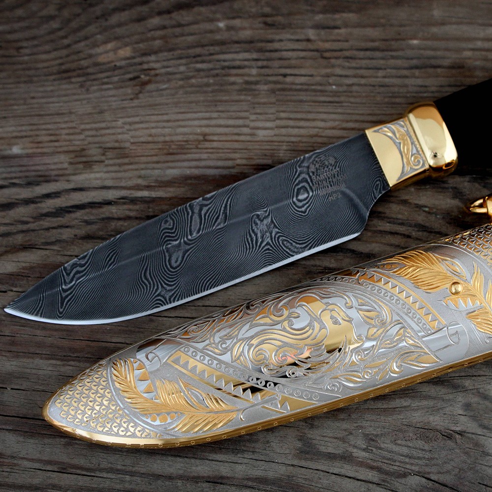 Damascus blade and metal scabbard with engraved eagle pattern.