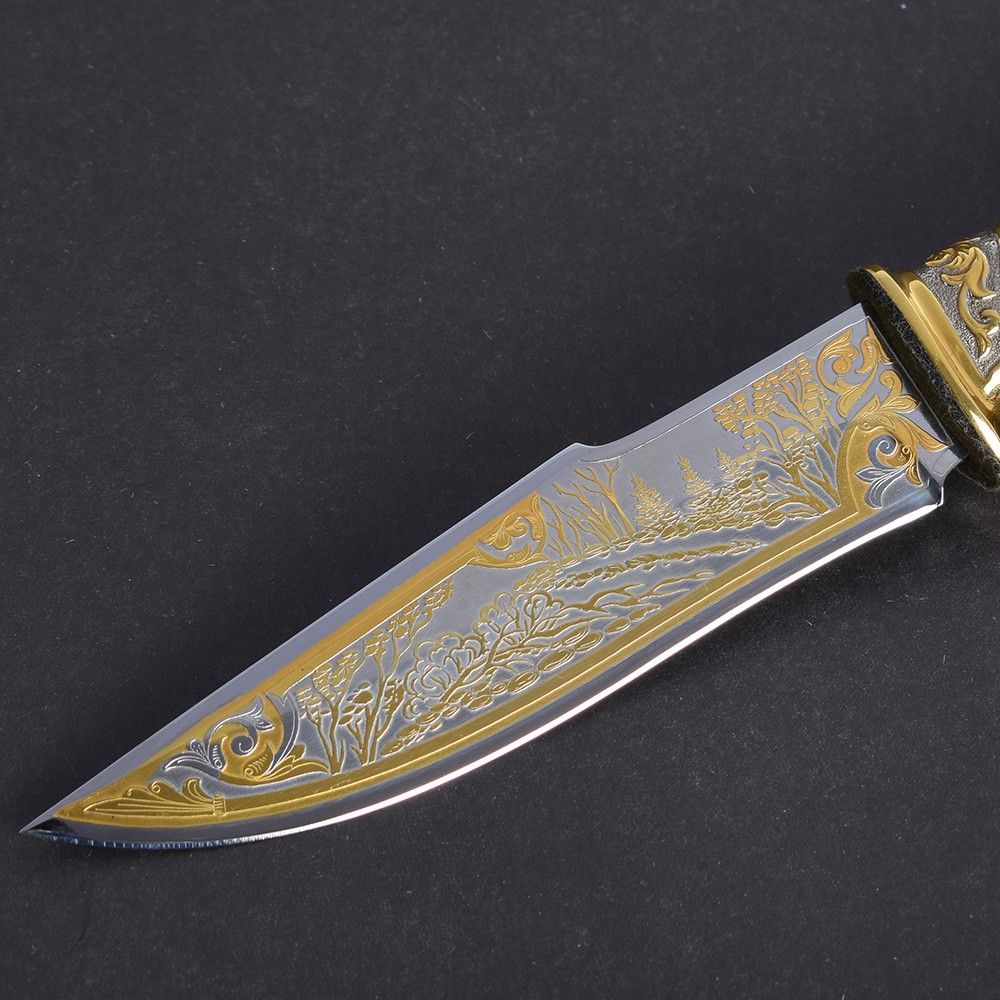 Knife blade made of modern steel with embossed gold pattern on the surface