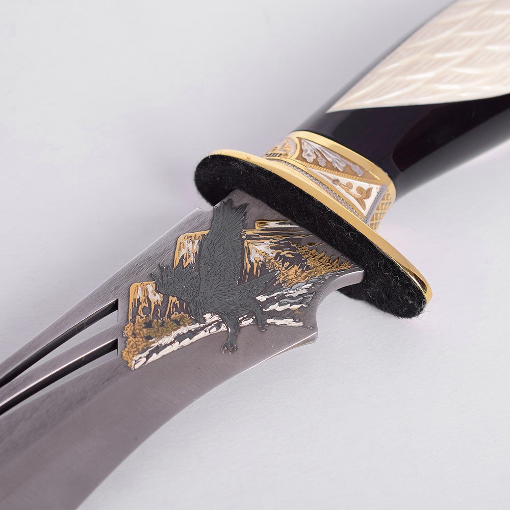 Perforated knife blade with an eagle pattern. Exclusive knife decor