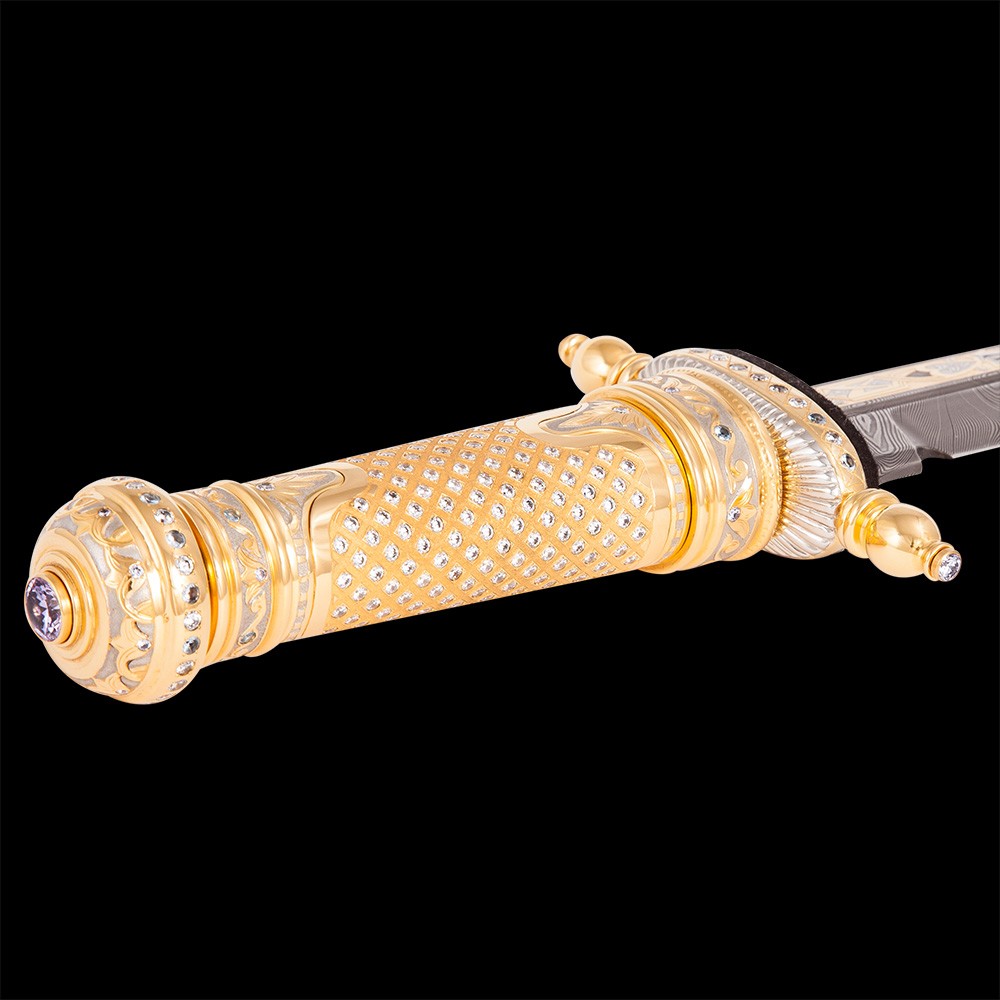 The golden hilt of a dagger strewn with transparent crystals.
