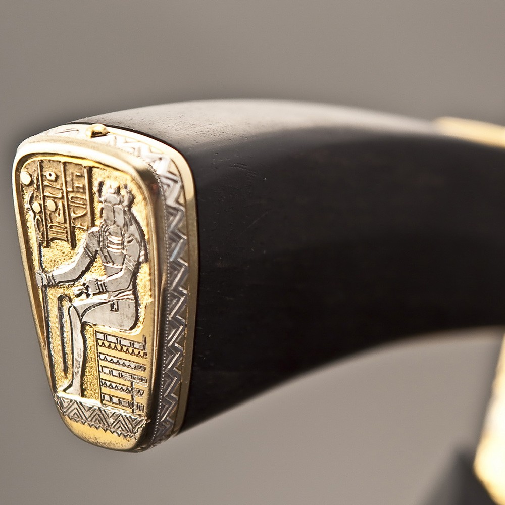 The back of the knife depicts Khepri himself with a scarab head and a royal rod in his hand.