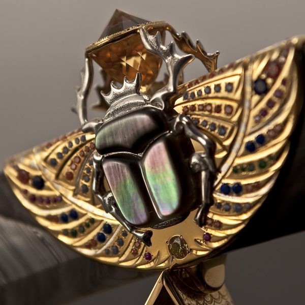 Depicted in the form of the sacred scarab beetle, God Khepri symbolizes the invisible power of creation which gives impetus to the movement of our sun in the sky and all things.