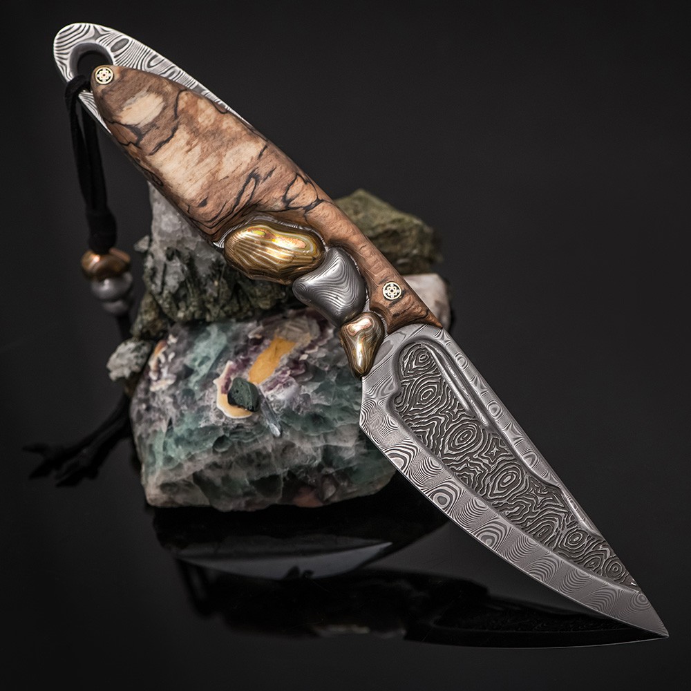 Japanese damascus knife decorated with mokume gane. The handle is carved from a piece of wood