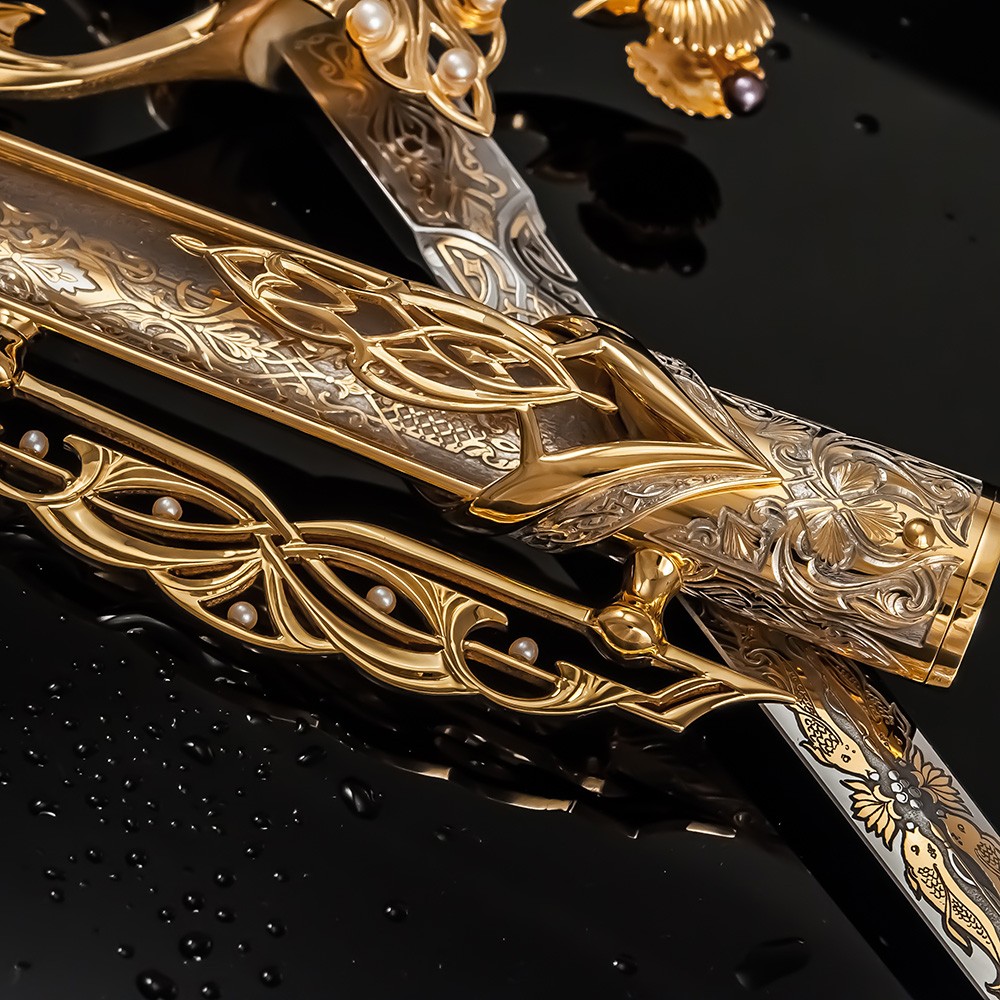 The golden sheath of the Qatari dagger is decorated with engraving and pearls