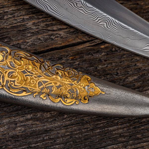 Metal sheath of jewelry work. Silver rhodium plating. On the surface, a floral ornament covered with gold is manually carved.