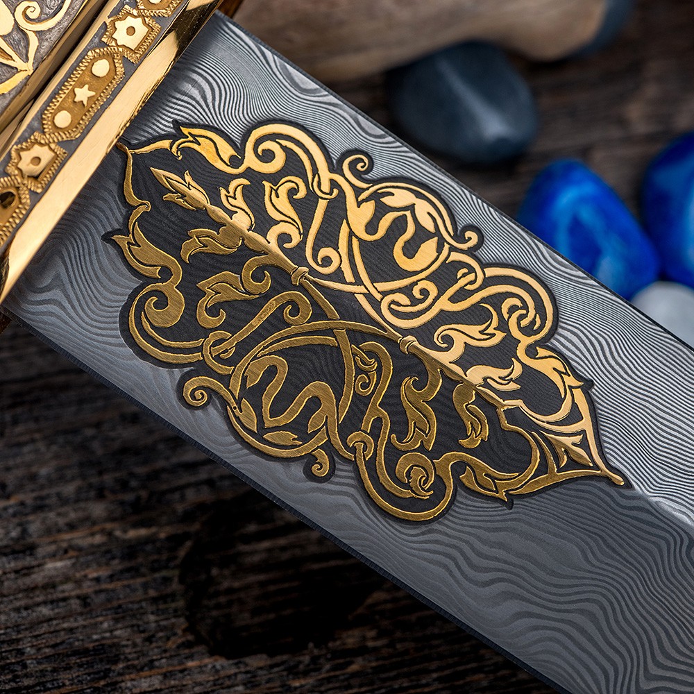 Damascus blade decorated with gold ornaments.