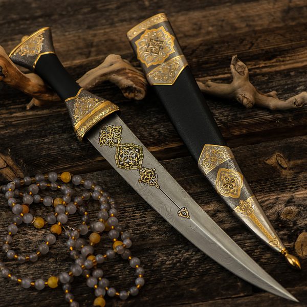Luxurious arabic dagger made of noble materials. The dagger blade is forged from art damask with gold script. Exclusive gift for men.