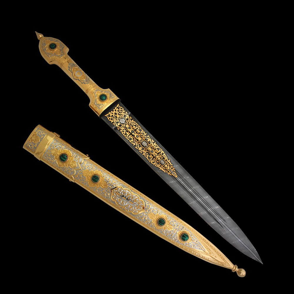 The dagger blade is made of strong damask steel. To decorate metal elements of the hilt and scabbard, as well as blade surfaces, the techniques of Zlatoust engraving on metal were used. These include brush painting, needle engraving on varnish, etching, engraving with a cutter, polishing, and inserts of precious malachite. Nickel plating and gilding emphasize the beauty of the design and details.