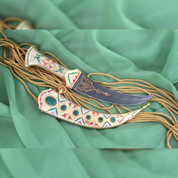 Damascus dagger jambia. The scabbard is decorated with cabochons of green malachite and enamel designs of red and green enamel.