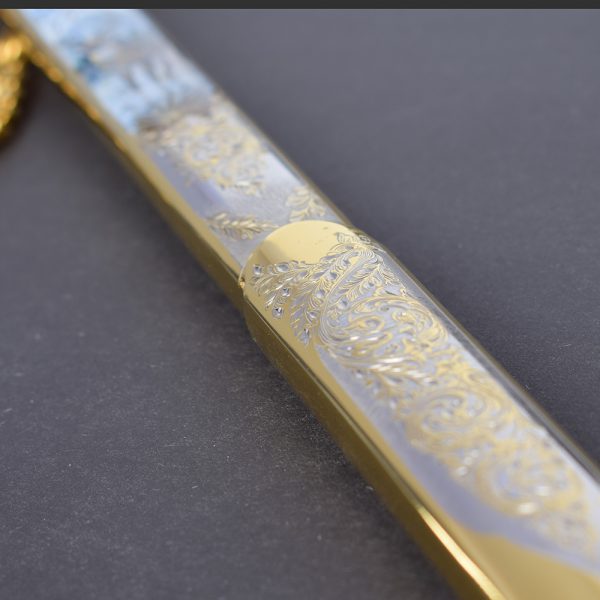 Metal sheath coated with Zlatoust engraving on metal. Surface tinted with gold and nickel.