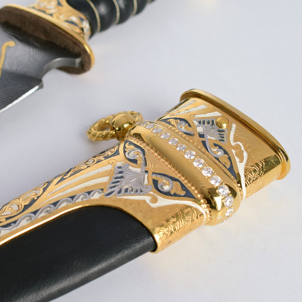Sheath decorated with embossed engraving and transparent crystals.