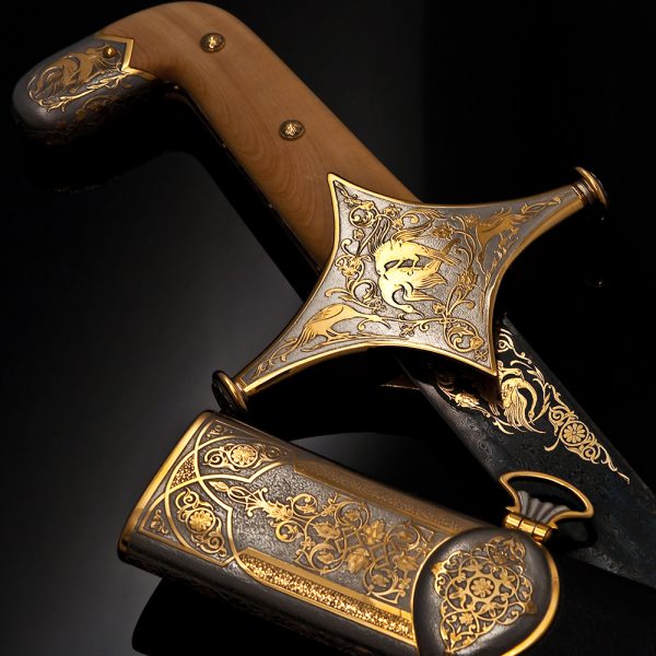 Shamshir sword decorated with gold and carvings of birds.