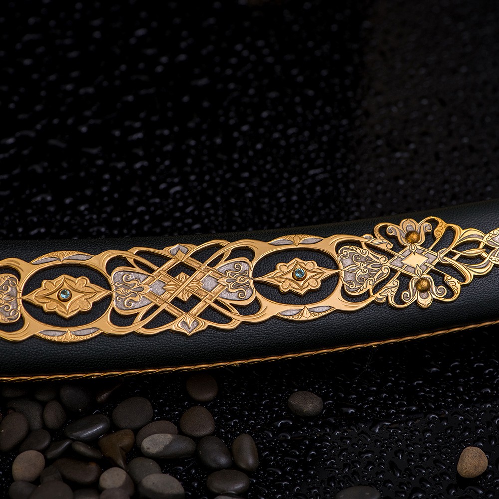 Leather-sheathed arabic sword decorated with gold carvings with blue crystals