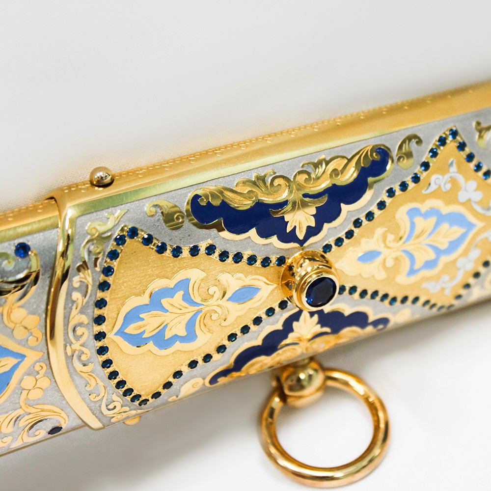 Gold sheath decorated with a scattering of blue stones and artistic enamel