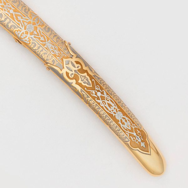 Saber scabbard decorated with a hand-made engraver under a microscope.