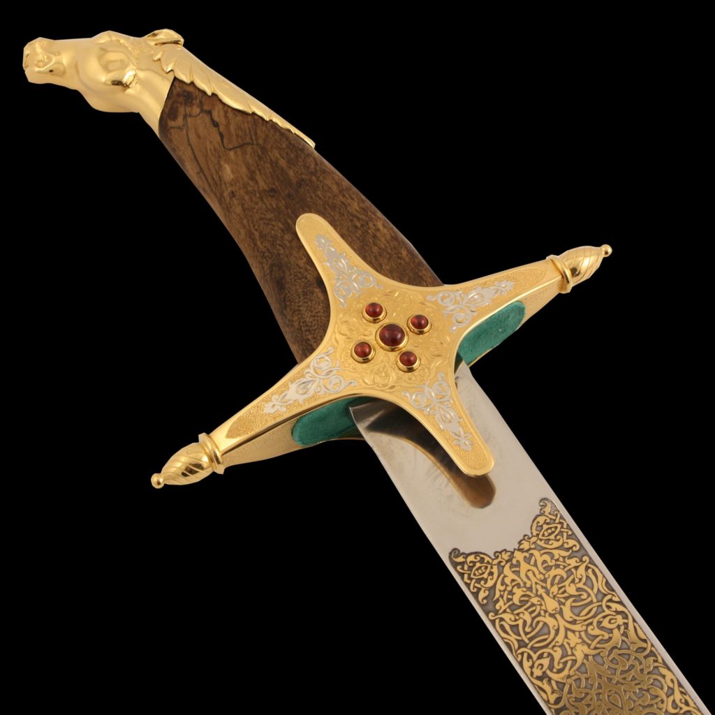 Luxurious arabian sword adorned with stones and a golden horse head