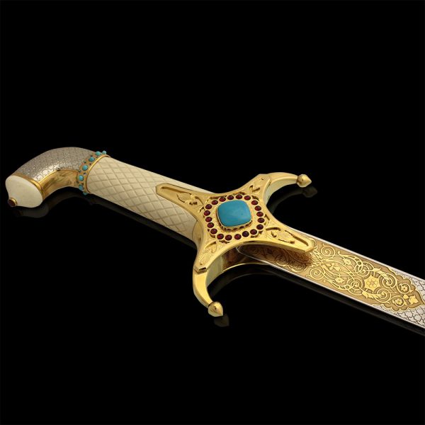 The handle of the Arabian sword of bone, decorated with stones and gold