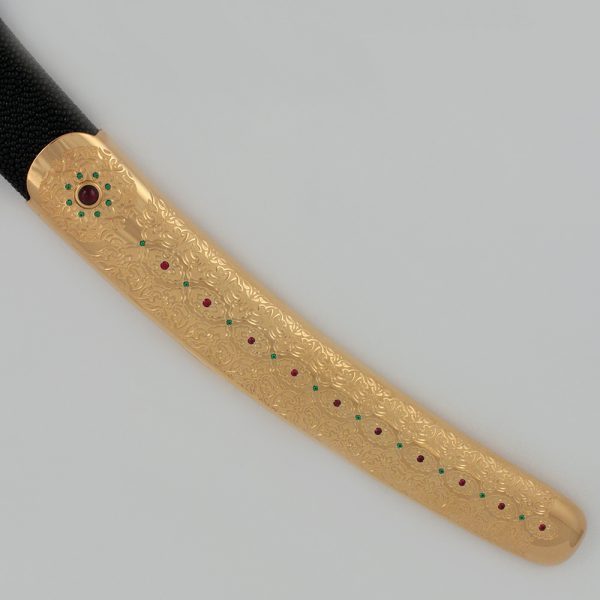 Scabbard of arab saber. The scabbard is traditionally plated with gold and oriental ornaments.