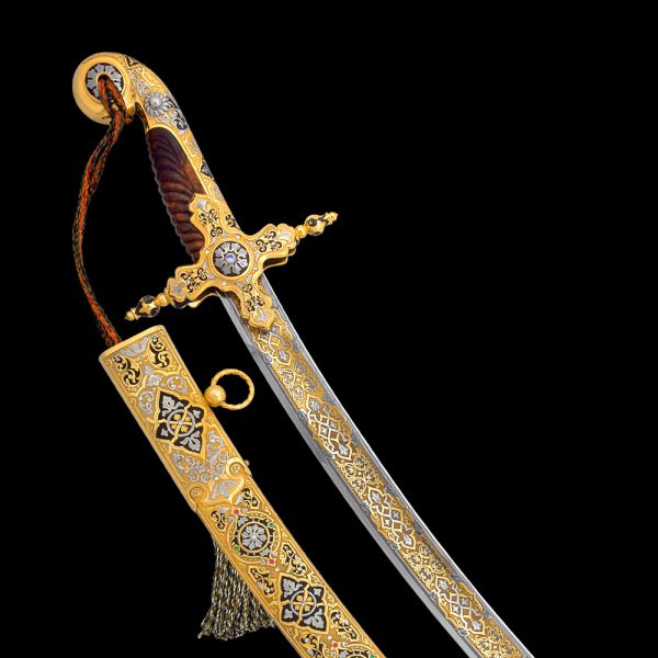 Oriental saber richly decorated with hand engraving, gold and crystals.