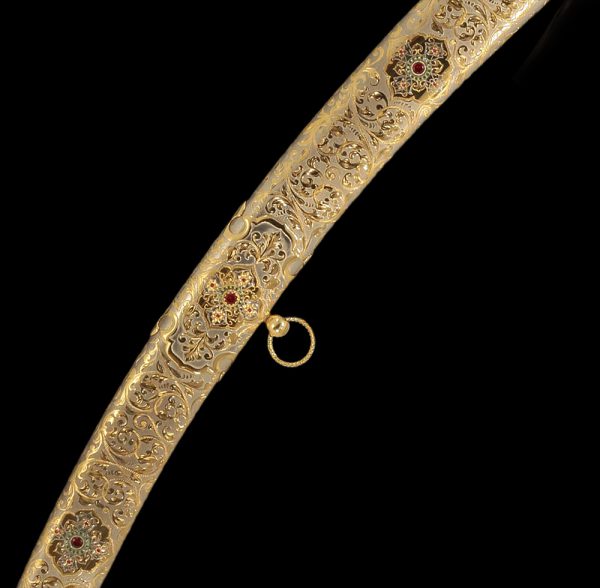The art of decorating weapons. Gold sheath decorated with stones and drawings