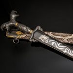 Luxurious Japanese sword with a blade decorated with a silver dragon.
