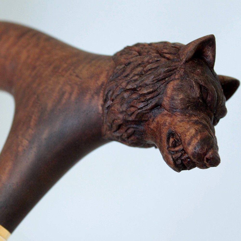 Wooden hilt with a carved wolf head.