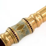 Golden cane decorated with burgundy stones