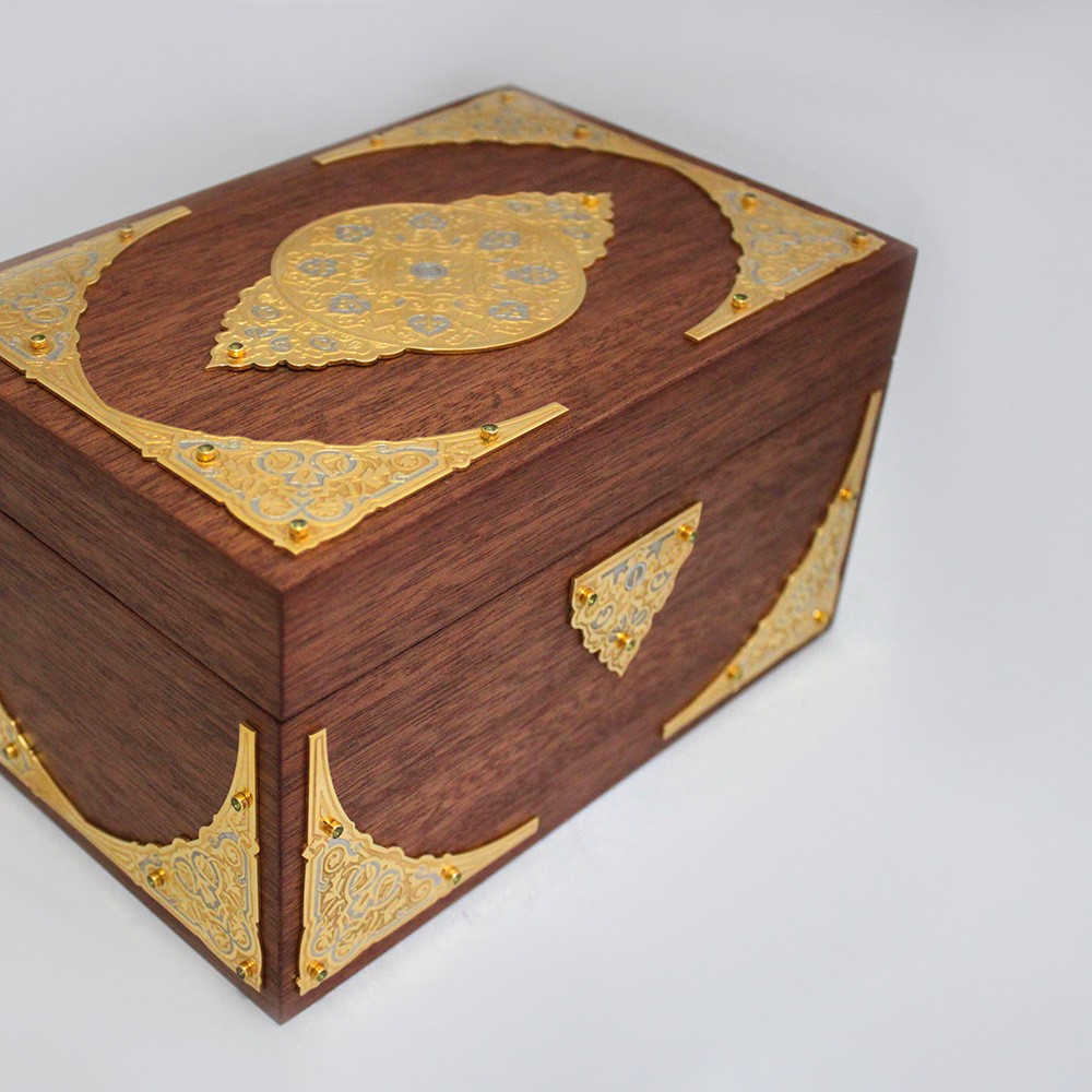 The box is decorated with metal plates with engraved patterns.
