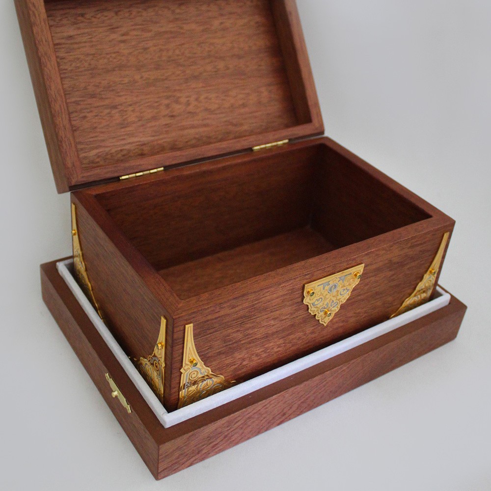 Handmade natural casket. The box is decorated with gold lining with jewelry stones.