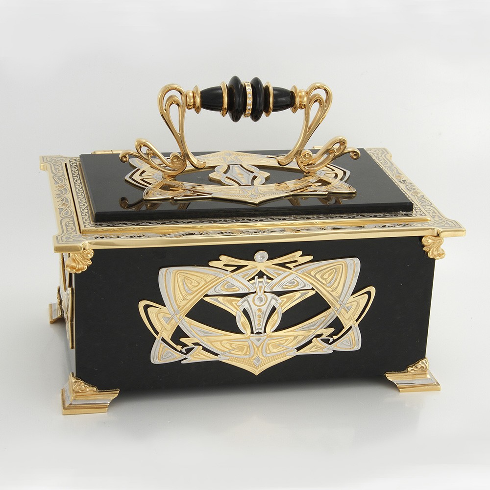 Casket made of natural stone. Handwork of jewelers and stone cutters decorated with decorative overlays.