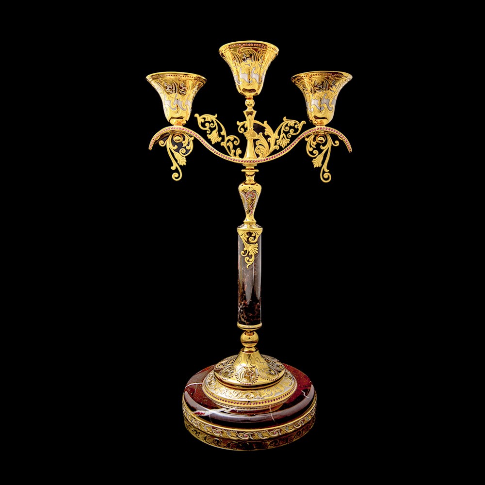 An elegant three-arm candle holder is a combination of the most famous and widespread gem on earth – jasper and finely crafted, decorated metal parts