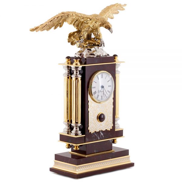 The natural mineral jasper is a stone-healer, a stone closely associated with the elements of air. The eagle, a mighty symbol of the sky, emphasizes the element of air. There are metal columns on the sides of the clock.