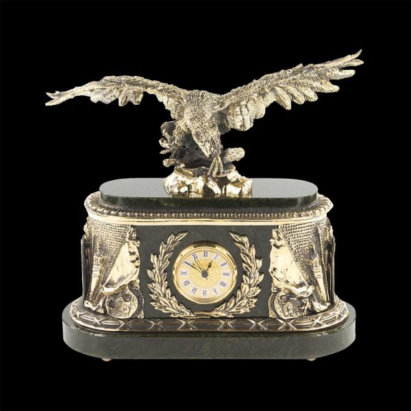 A clock with a sculpture of a feathered predator decorating the monumental case creates a place of power in the interior.