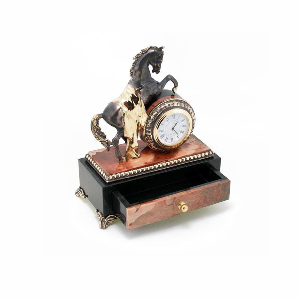 Handmade stone casket with a clock and a steel statuette of a horse.