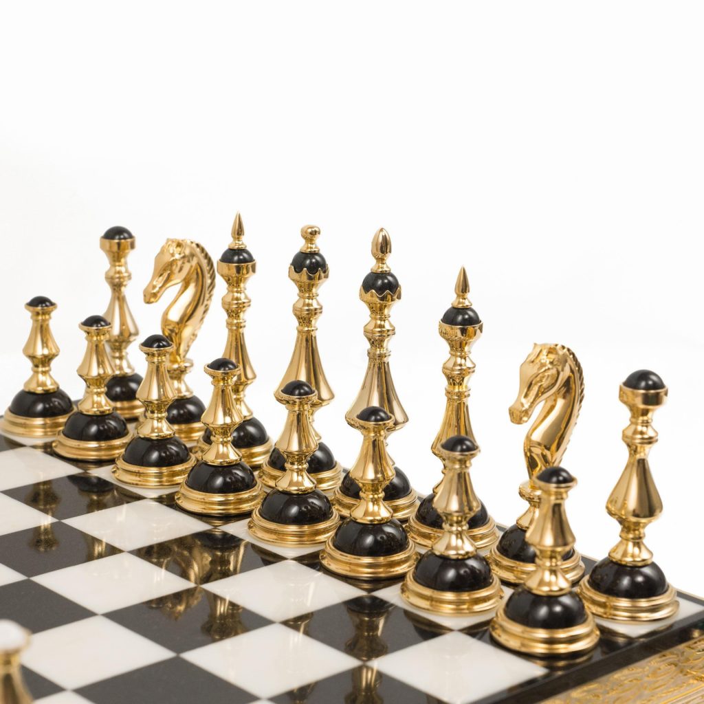 Black chess pieces made of gold and stone. A luxurious item for interior decoration.
