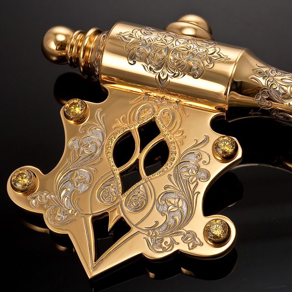 Golden key decorated with yellow crystals