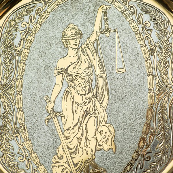 Golden image of the goddess of justice. Zlatoust engraving on metal