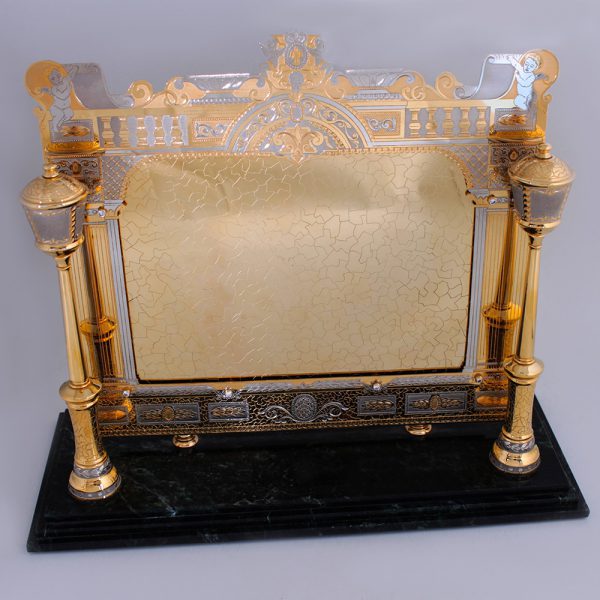 Golden photo frame for interior decoration. Luxurious handwork of jewelers, stone cutters and engravers.