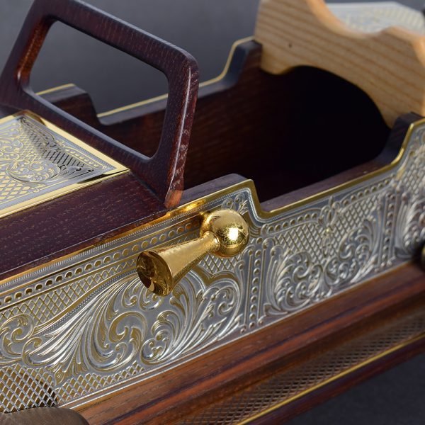 Wooden car model decorated with metal trim. The surface of the pads is indicated by hand engraving using a cutter and a microscope. All metal elements are gold plated.