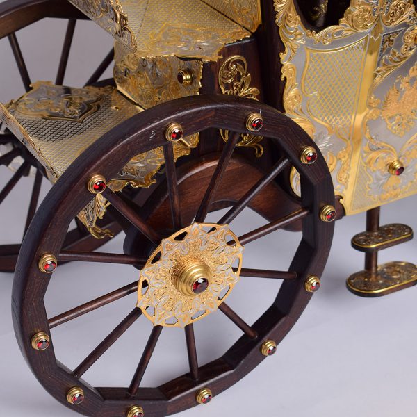 Wooden carriage wheels with inlaid jewelry stones.