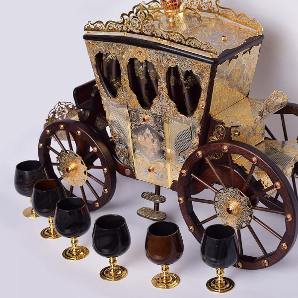Piece of art. Big golden carriage with stone glasses. A luxurious item for interior design.