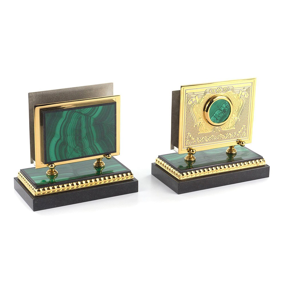 Business card holders are carved by the master from stone. Metal surfaces coated with gold and relief engraving